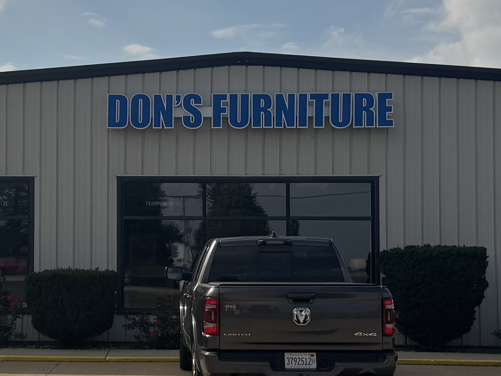 Dimensional blue channel letters spelling Don’s Furniture on the storefront