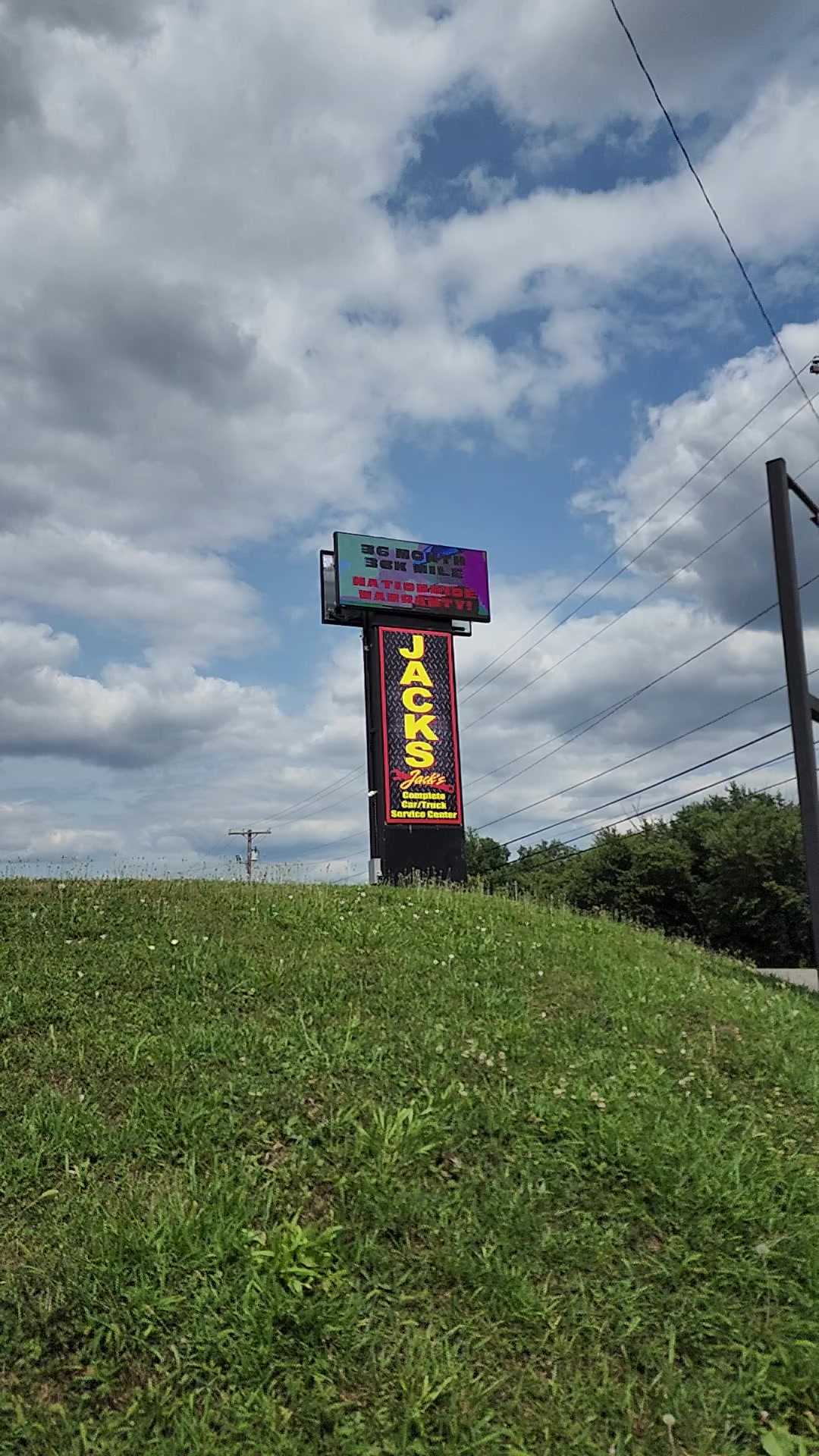 Jack's Complete Car/Truck Service Center roadside pylon sign with a digital message display