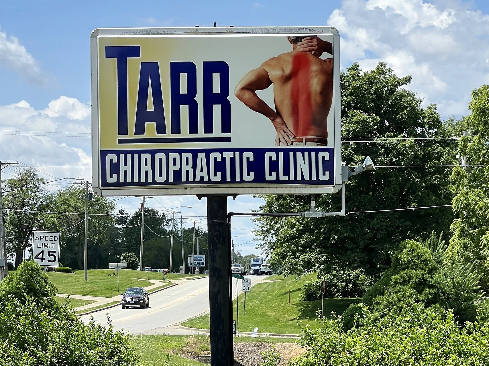 Tarr Chiropractic Clinic pylon sign with a lighted cabinet beside the road