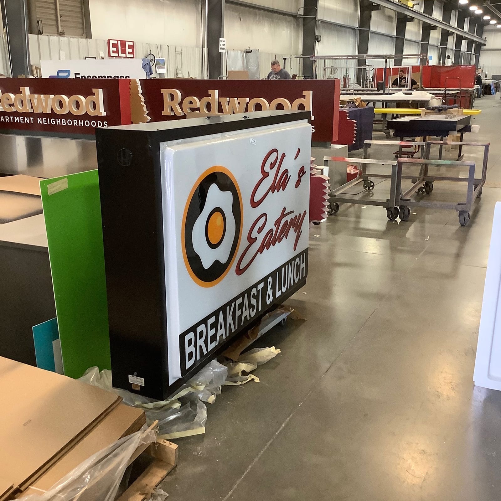 Ella's Eatery illuminated sign during production