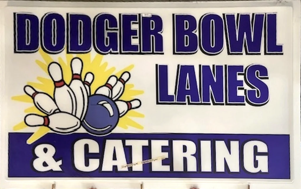 Dodger Bowl Lanes & Catering sign face in purple and yellow, photographed during fabrication